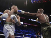 Floyd Mayweather Jr. connects to the face of Conor McGregor during their super welterweight match Saturday at Las Vegas.