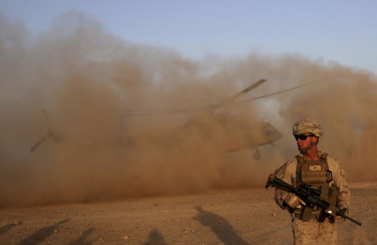 A U.S. Marine takes part in a training session Sunday for Afghan army commandos in Shorab military camp in Helmand province, Afghanistan.