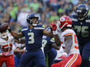 Seattle Seahawks quarterback Russell Wilson (3) looks to pass against the Kansas City Chiefs during the first half of an NFL football preseason game, Friday, Aug. 25, 2017, in Seattle.