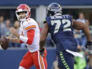 Seattle Seahawks defensive end Michael Bennett (72) pressures Kansas City Chiefs quarterback Alex Smith during the first half of an NFL football preseason game, Friday, Aug. 25, 2017, in Seattle.