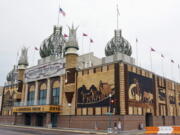 FILE - This Sept. 1, 2015, file photo shows the Corn Palace in Mitchell, S.D. The corn-themed tourist destination will have enough corn to decorate murals despite a dry summer. The director of the Corn Palace said that the city has enough corn to create the nine corn murals surrounding the facility thanks to recent rain. About 275,000 ears of corn are needed for the building, which is currently adorned with 2-year-old dilapidated murals.