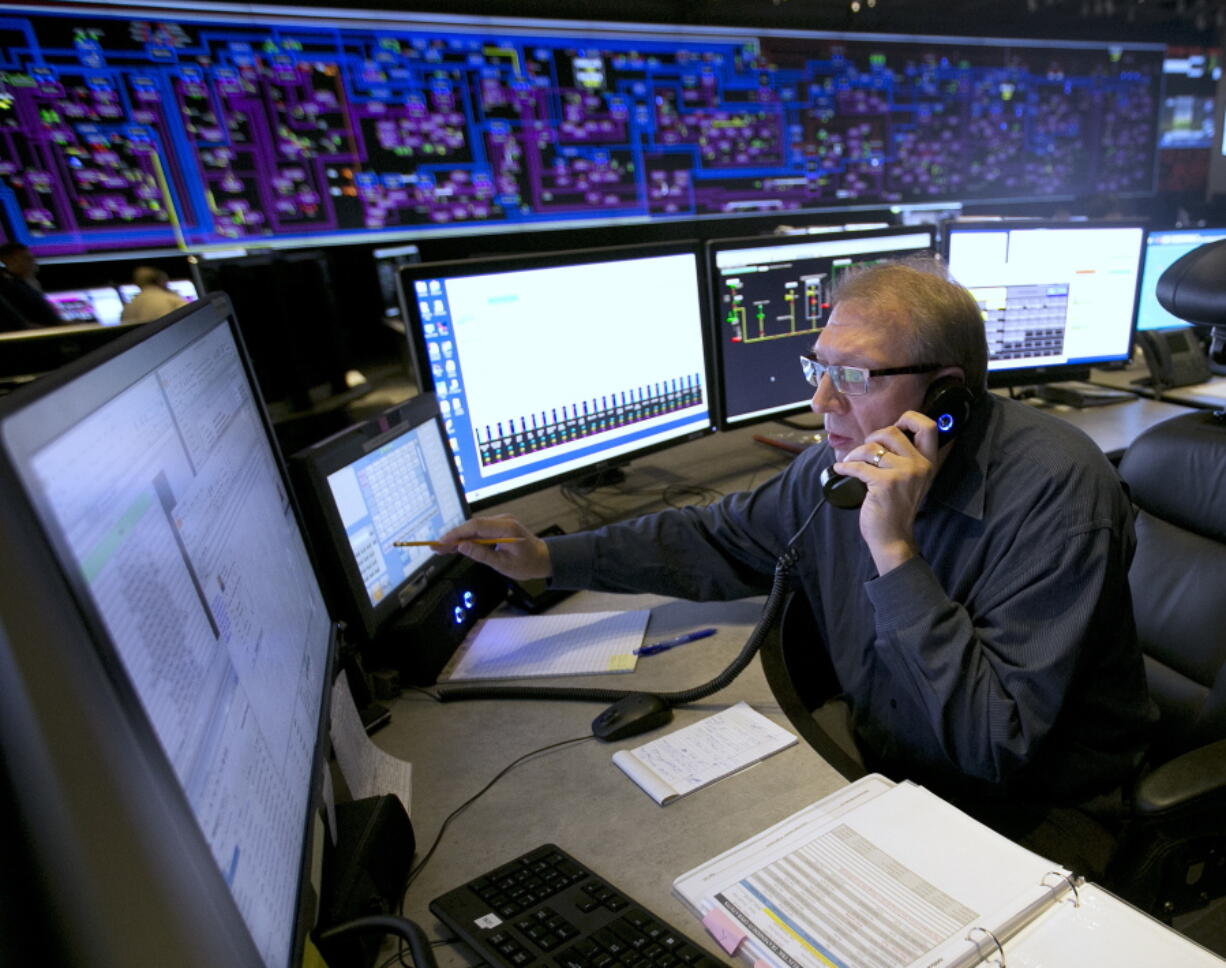 Shift Supervisor Gary Anderson monitors the power system flow and conditions at the Pacific Gas & Electric grid control center, in Vacaville, Calif., Aug. 7. Power grid managers say they’ve been preparing extensively for more than a year for Monday’s solar eclipse.