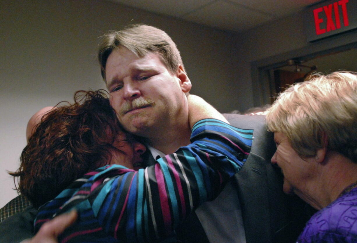 Steven Barnes receives a hug from sister Lisa Pawloski, beside his mother Sylvia Bouchard, right, on  Nov. 25, 2008 moments after Barnes was released from prison in Utica, N.Y. Family and friends packed the Oneida County Court room for the hearing where Judge Michael Dwyer overturned Barnes’ 1989 conviction for the 1985 rape and murder of 16-year-old Kimberly Simon, based on new DNA evidence.