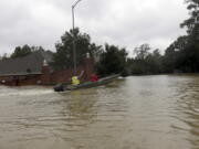 A rescue boat enters a flooded subdivision as floodwaters from Tropical Storm Harvey rise Monday in Spring, Texas. (AP Photo/David J.