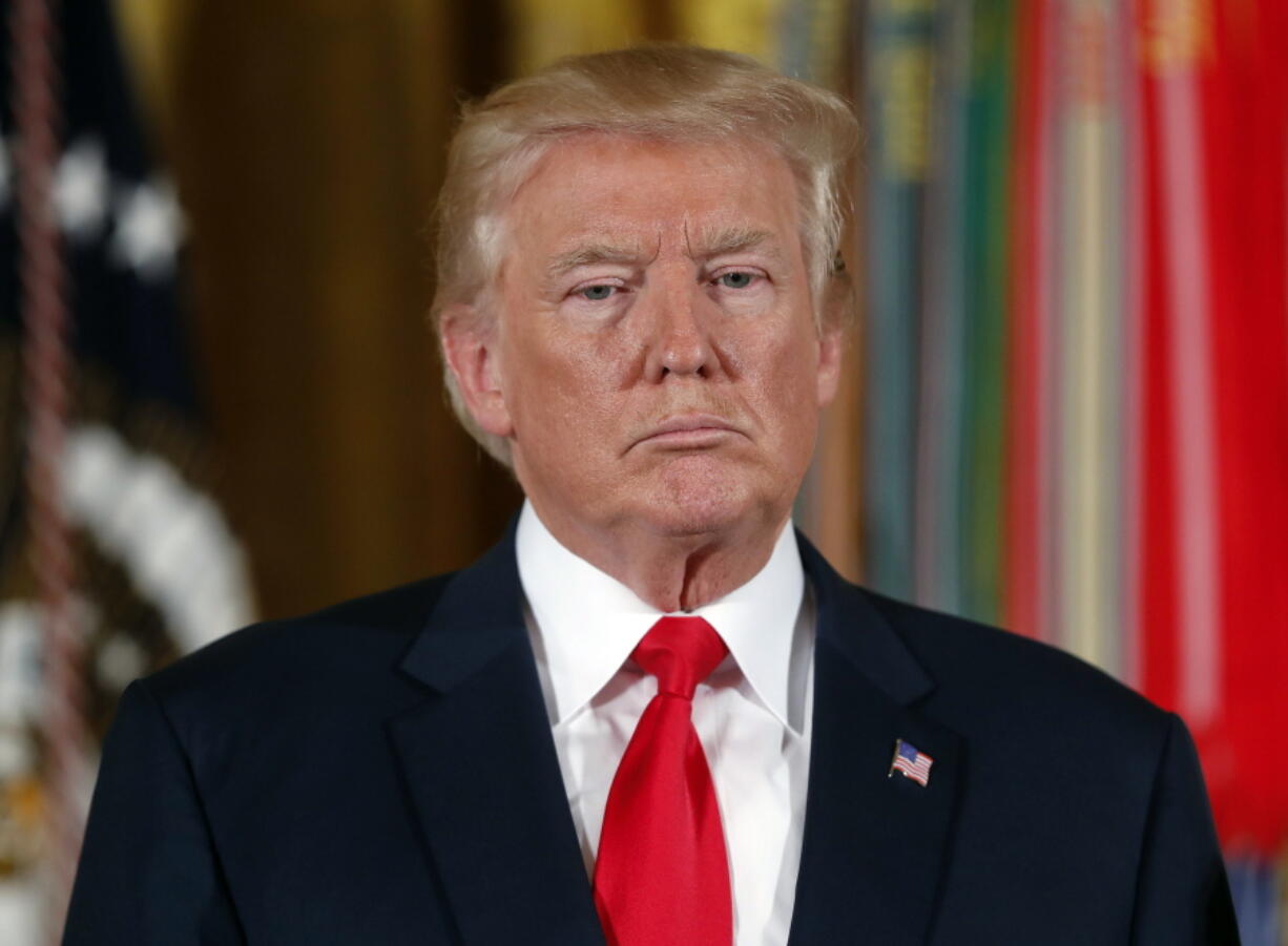 President Donald Trump pauses during a ceremony in the East Room of the White House in Washington. Trump’s threat to stop billions of dollars in government payments to insurers and force the collapse of “Obamacare” could put the government in a tricky legal situation. Legal experts say he’d be handing insurers a solid court case, while undermining his own leverage to compel Democrats to negotiate, especially if premiums jump by 20 percent as expected after such a move.