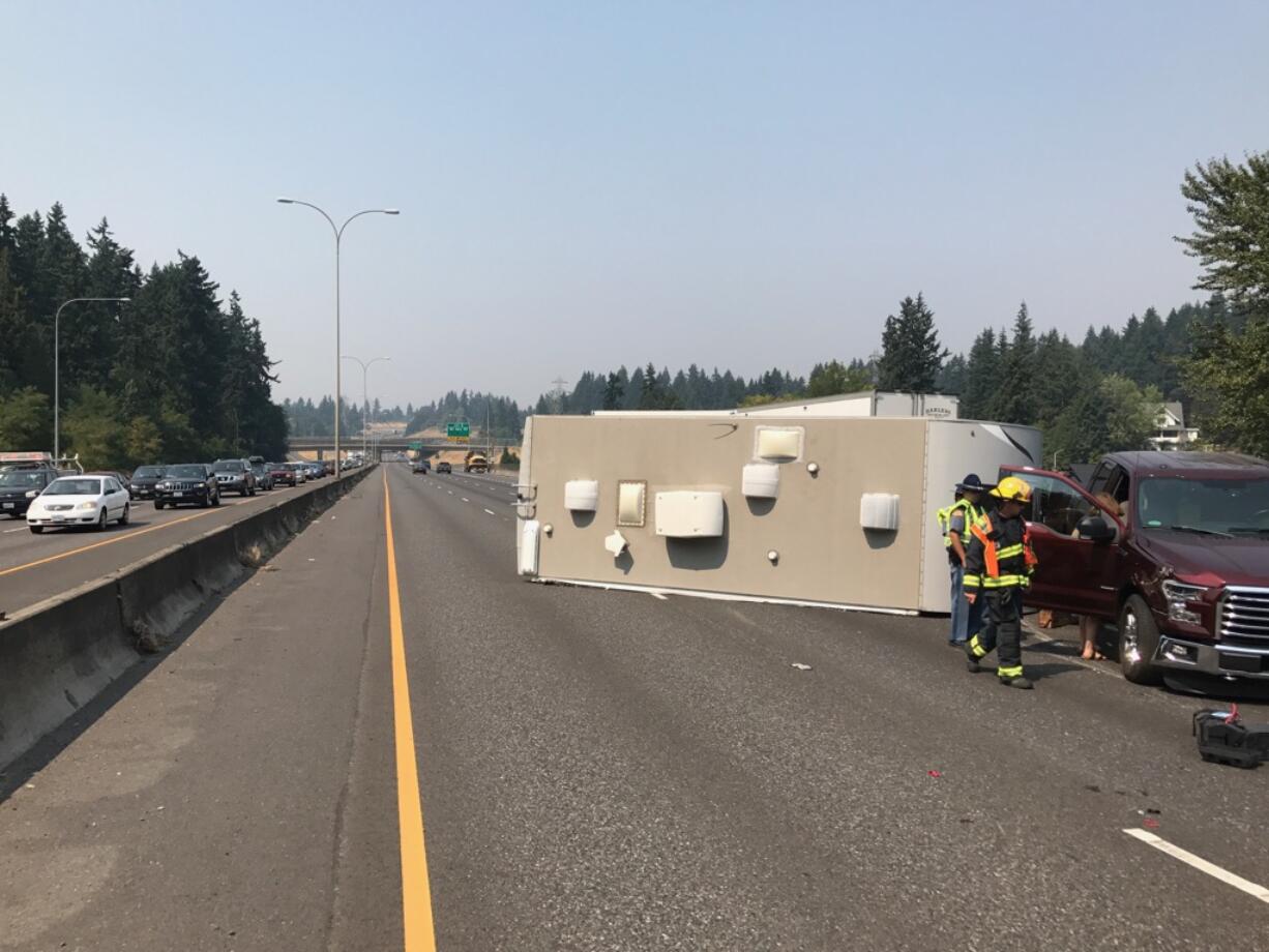 Firefighters survey the damage after a rollover on Interstate 5 south of Northeast 78th Street Thursday afternoon.