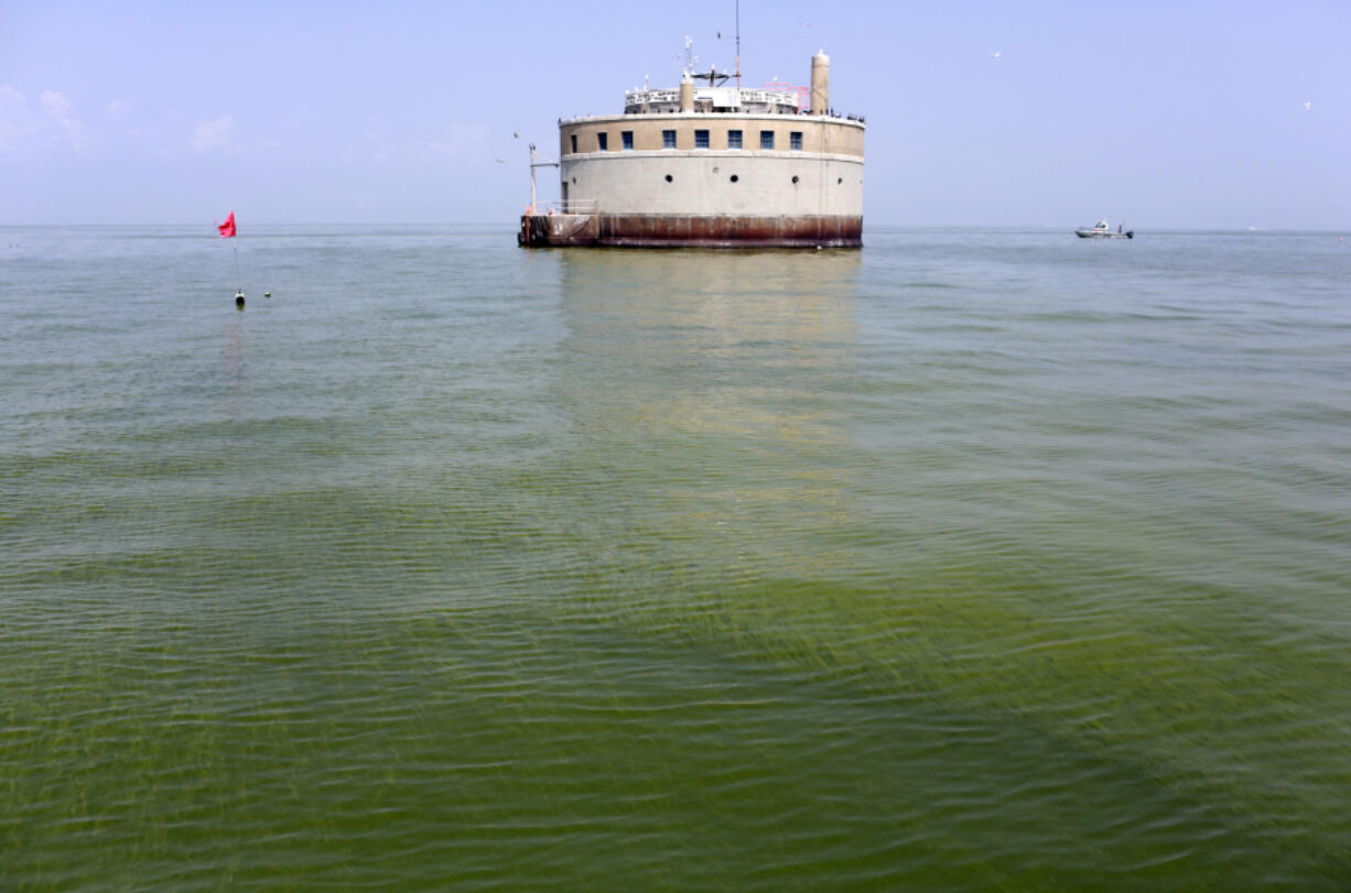 The water intake crib for the city of Toledo, Ohio, is surrounded by an algae bloom on Lake Erie, about 2.5 miles off the shore of Curtice, Ohio. Researchers are working on creating an early warning system that can spot when algae begins showing up on hundreds of lakes across the U.S., using real-time data from satellites that already monitor harmful algae hotspots on Lake Erie in Ohio and on the Chesapeake Bay along the East Coast. (AP Photo/Haraz N.
