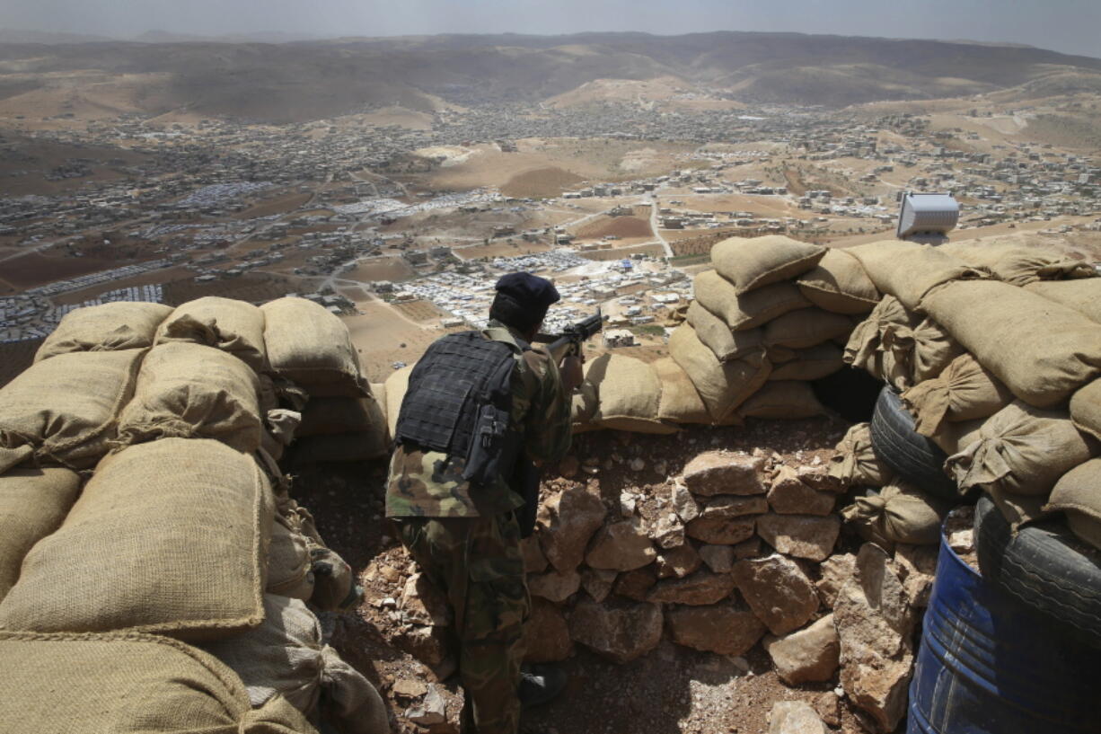 A Lebanese army soldier takes his position overlooking an area controlled by the Islamic State group at the edge of the town of Arsal, in northeast Lebanon. Lebanon’s U.S.-backed military is gearing up for a long awaited assault to dislodge hundreds of IS militants from a remote corner of northeastern Lebanon near the border with Syria, seeking to end a years-long threat posed to neighboring towns and villages by the extremists.