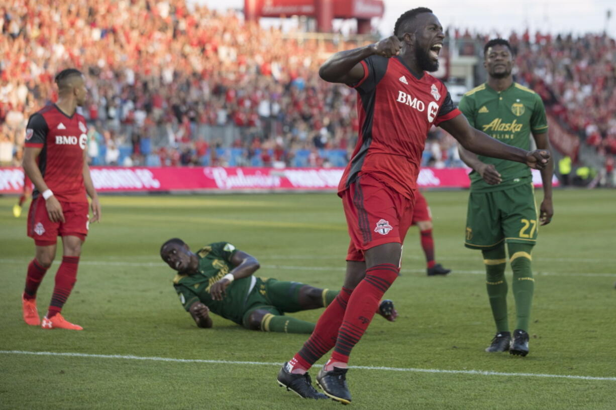 Toronto FC forward Jozy Altidore celebrates after Justin Morrow, left, scored against the Portland Timbers during the second half of an MLS soccer match Saturday, Aug. 12, 2017, in Toronto.