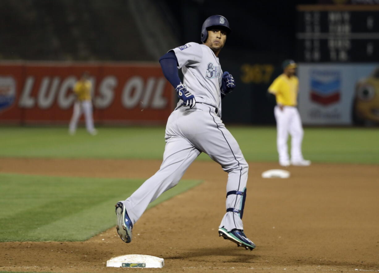 Seattle Mariners’ Leonys Martin looks back to his dugout as he rounds the bases following a solo home run during the 10th inning of a baseball game against the Oakland Athletics Tuesday, Aug. 8, 2017, in Oakland, Calif. Seattle won 7-6.