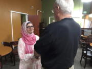 Moina Shaiq speaks to a man after a Meet a Muslim event July 10 at Bronco Billy’s Pizza Palace in Fremont, Calif. Shaiq discussed the importance of the hijab, the head scarf, and the niqab, the face covering, as well as the differences between Sunnis and Shias. (AP Photo/Kristin J.