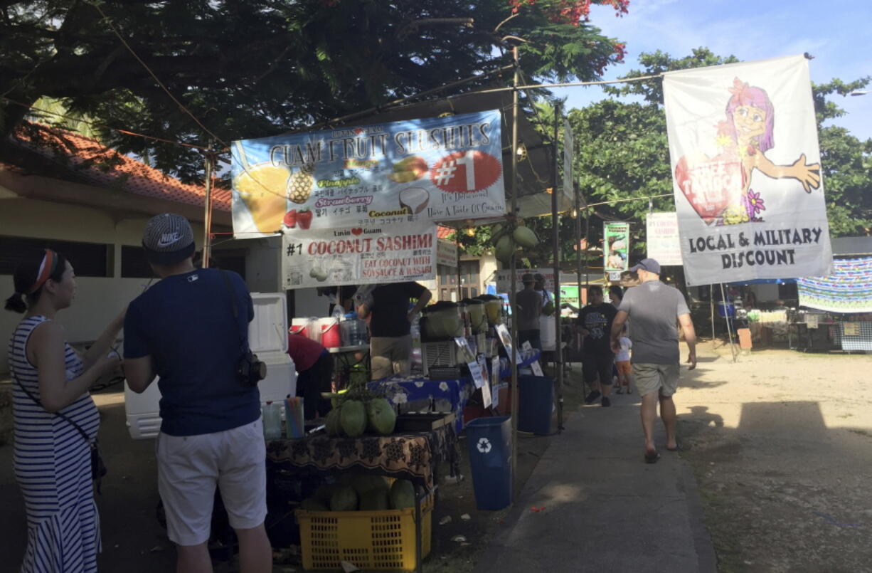 People walk through the Chamorro Village marketplace in Hagatna, Guam, Wednesday, Aug. 9, 2017. The market is popular among U.S. military members, locals and tourists in the territory’s capital city. Residents of the tiny Pacific island say they’re afraid of being caught in the middle of escalating tensions between the U.S. and North Korea after Pyongyang announced it was examining plans for attacking the strategically important U.S. territory.