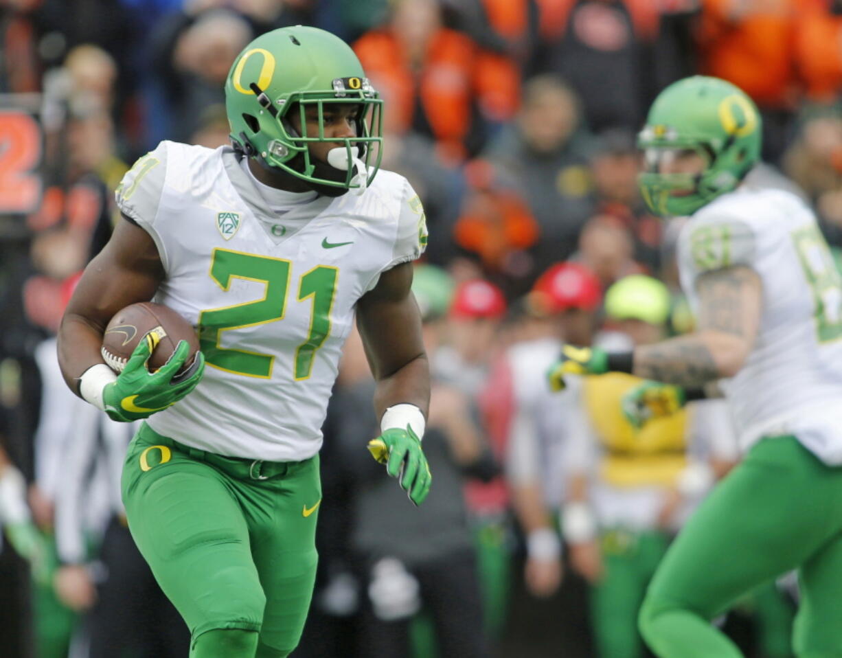 After the trials of last season, Oregon running back Royce Freeman (21) appears to have emerged with two things: a college degree and a bright outlook. (AP Photo/Timothy J.