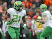 After the trials of last season, Oregon running back Royce Freeman (21) appears to have emerged with two things: a college degree and a bright outlook. (AP Photo/Timothy J.