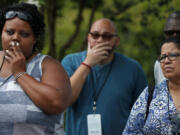 Visitors listen as a guide speaks about the enslaved people who lived at the Whitney Plantation.