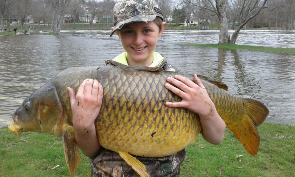 Chase stokes, then 10, holding a giant carp, weighing 33.25 pounds, April 17 in Ferrisburgh, Vt. The Vermont Fish & Wildlife Department made the record official a few weeks ago, stating that the fish was a quarter-pound bigger than the previous record holder.