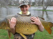 Chase stokes, then 10, holding a giant carp, weighing 33.25 pounds, April 17 in Ferrisburgh, Vt. The Vermont Fish & Wildlife Department made the record official a few weeks ago, stating that the fish was a quarter-pound bigger than the previous record holder.