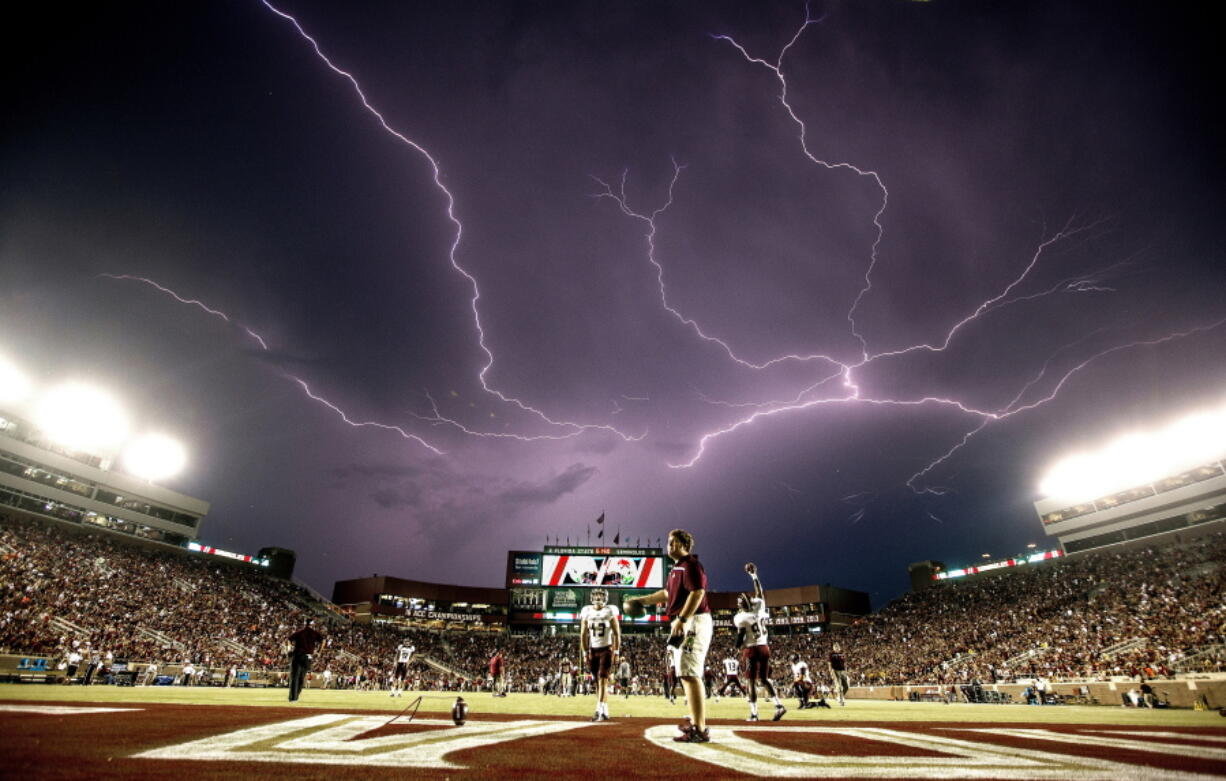 A lightning strike occurs in 2015 as Texas State warms up in Doak Campbell Stadium before a college football game against Florida State in Tallahassee, Fla. Lightning used to kill about 300 Americans a year, but lightning deaths are on pace to hit a record low this year. Scientists say less time spent outside and improved medical treatment have contributed to fewer deaths.