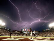 A lightning strike occurs in 2015 as Texas State warms up in Doak Campbell Stadium before a college football game against Florida State in Tallahassee, Fla. Lightning used to kill about 300 Americans a year, but lightning deaths are on pace to hit a record low this year. Scientists say less time spent outside and improved medical treatment have contributed to fewer deaths.