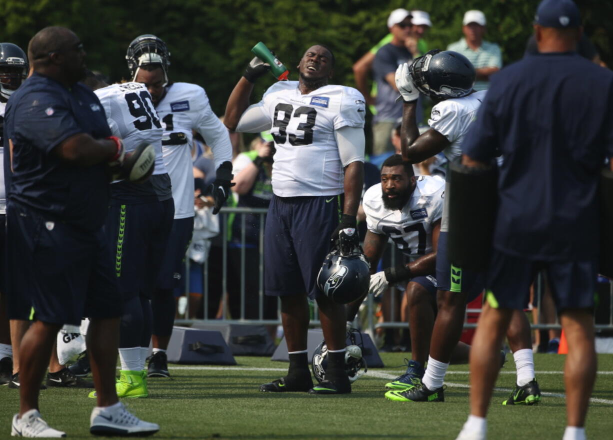 Seattle Seahawks defensive tackle Jeremy Liggins (93) cools down with a water bottle during NFL football training camp, Thursday, Aug. 3, 2017, in Renton, Wash.