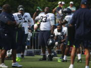 Seattle Seahawks defensive tackle Jeremy Liggins (93) cools down with a water bottle during NFL football training camp, Thursday, Aug. 3, 2017, in Renton, Wash.