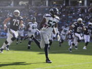 Seattle Seahawks linebacker Terence Garvin (52) runs back an interception for a touchdown against the Los Angeles Chargers Sunday during a preseason game. Garvin is making a strong case to be on the Seahawks’ 53-man roster. Jae C.