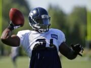 Seattle Seahawks strong safety Kam Chancellor passes the football while playing catch at the start of NFL football training camp, Tuesday, Aug. 1, 2017, in Renton, Wash. (AP Photo/Ted S.