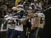 Seattle Seahawks wide receiver Kenny Lawler (11) celebrates with teammates after scoring a touchdown during the second half of Seattle’s 17-13 win.