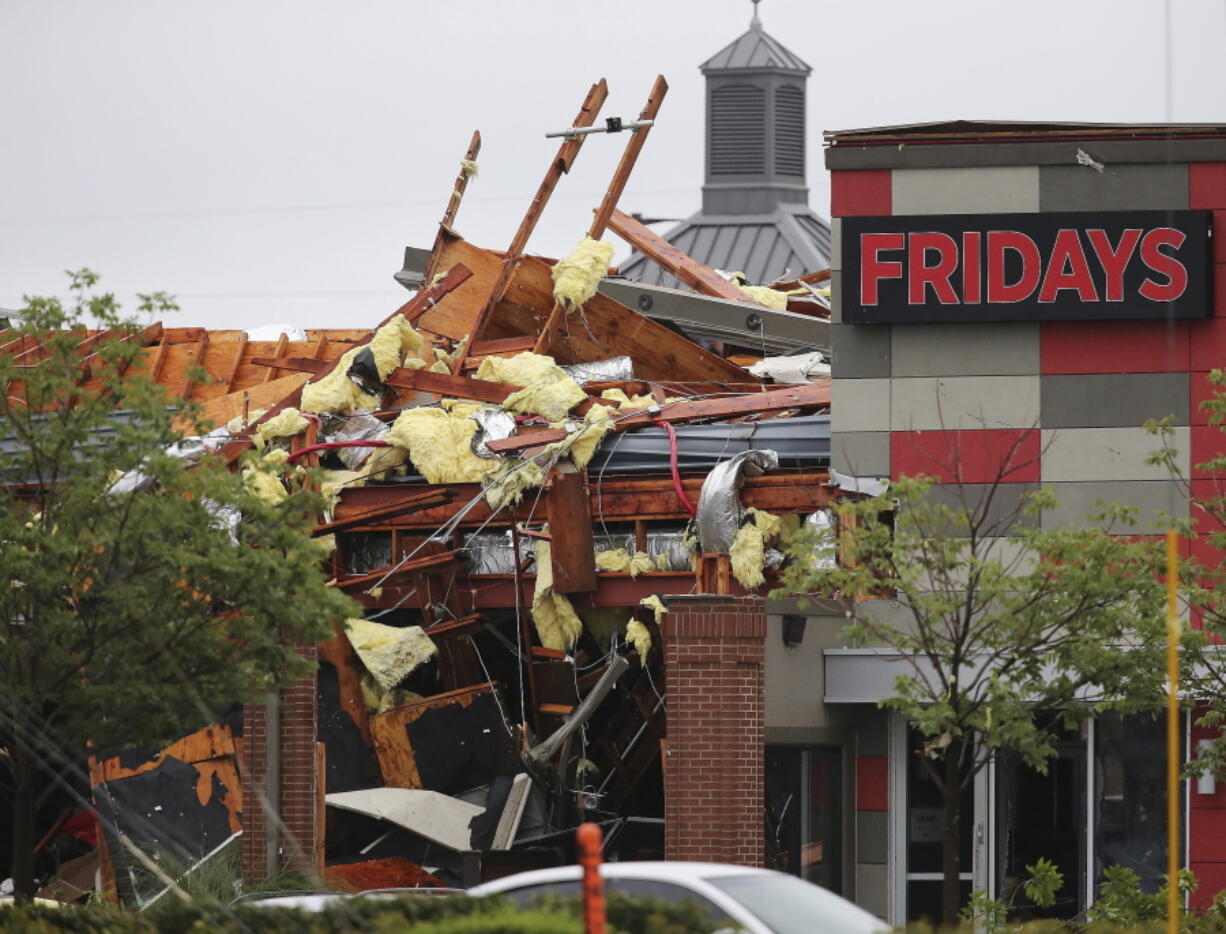 This photo shows damage to a Fridays restaurant after a storm moved through the area in Tulsa, Okla., Sunday, Aug. 6, 2017. A possible tornado struck near midtown Tulsa and causing power outages and roof damage to businesses.