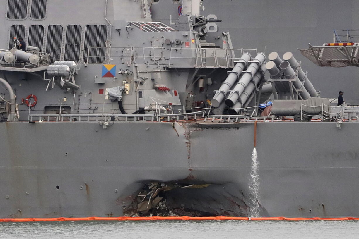 The damaged port aft hull of the USS John S. McCain is visible while docked at Singapore’s Changi naval base in Singapore. Divers have recovered the remains of all 10 sailors who went missing after the USS John S. McCain and an oil tanker collided near Singapore last week, the U.S. Navy said Monday, Aug. 28, 2017.