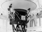 FILE - In this Aug. 4, 1977 photo provided by NASA, the "Sounds of Earth" record is mounted on the Voyager 2 spacecraft in the Safe-1 Building at the Kennedy Space Center, Fla., prior to encapsulation in the protective shroud. Sunday, Aug. 20, 2017 marks the 40th anniversary of NASA's launch of Voyager 2, now almost 11 billion miles distant.