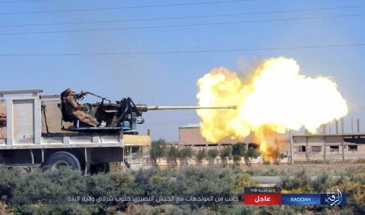 A gun-mounted vehicle operated by the group firing at Syrian troop in south eastern Raqqa, Syria. A Syria monitoring group says Islamic State militants have successfully pushed back government forces advancing on one of the last towns still in IS hands in the province of Raqqa.