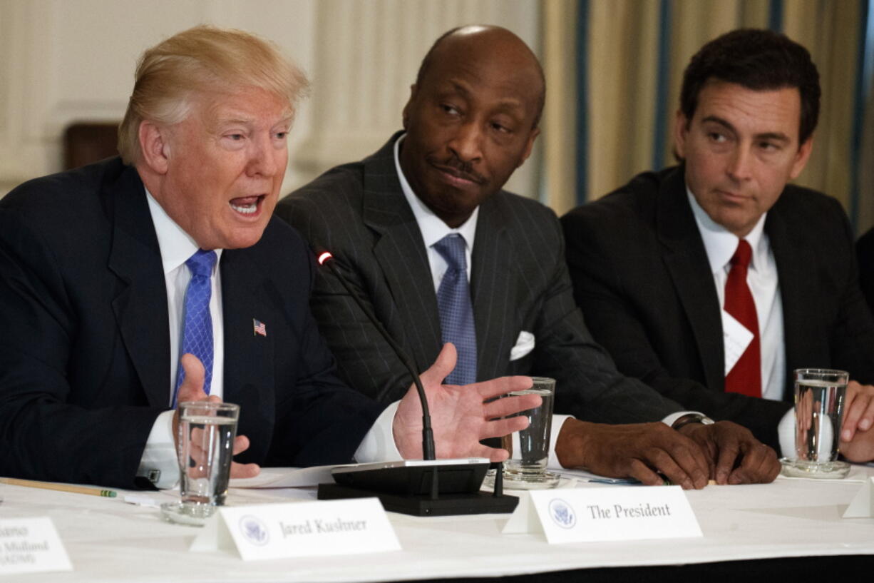 President Donald Trump, left, speaks during a meeting with manufacturing executives at the White House in Washington, including Merck CEO Kenneth Frazier, center, and Ford CEO Mark Fields. Frazier is resigning from the President’s American Manufacturing Council citing “a responsibility to take a stand against intolerance and extremism.” Frazier’s resignation comes shortly after a violent confrontation between white supremacists and protesters in Charlottesville, Va. Trump is being criticized for not explicitly condemning the white nationalists who marched in Charlottesville.