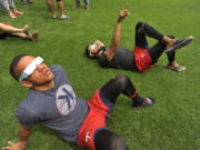 Minnesota Twins players Ehire Adrianza front, and Ervin Santana back, along with other members of the team watch the solar eclipse before a baseball game between the Minnesota Twins and Chicago White Sox Monday, Aug. 21, 2017, in Chicago.