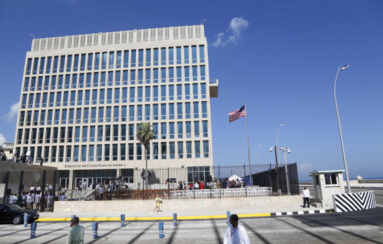 In this photo taken Aug. 14, 2015, a U.S. flag flies at the U.S. embassy in Havana, Cuba. At least 16 Americans associated with the U.S. Embassy in Havana suffered symptoms from attacks on their health in Cuba that have still not been explained, the United States said Thursday, Aug. 24, 2017.