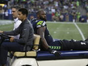 Seattle Seahawks offensive tackle George Fant is taken away on an injury cart after he went down on a play against the Minnesota Vikings in the first half of an NFL football preseason game, Friday, Aug. 18, 2017, in Seattle.