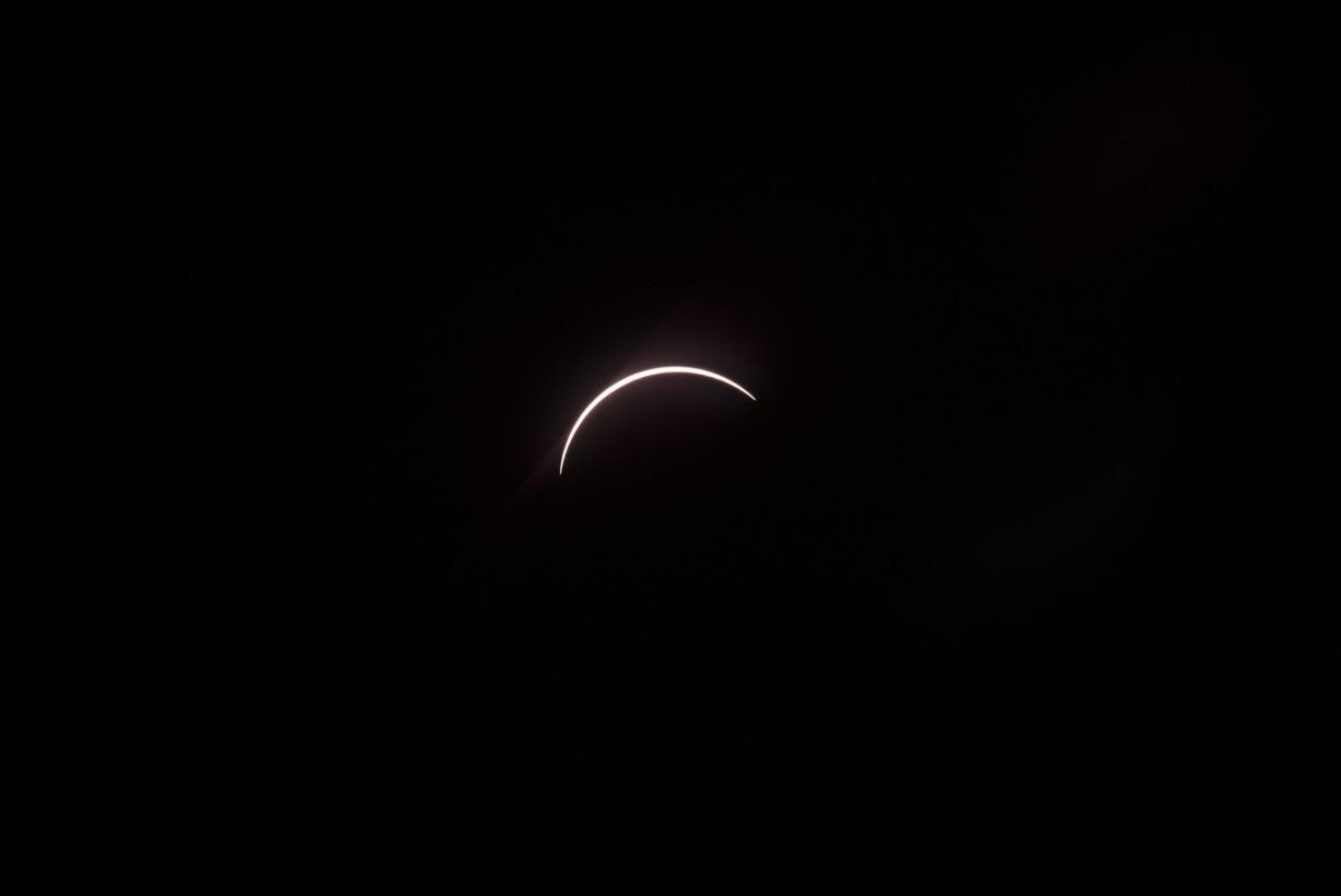 The moon eclipses the sun above the Vancouver Community Library on Monday morning. The next solar eclipse will be viewable from parts of the United States on April 8, 2024.