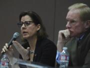 Sen. Ann Rivers, left, with Rep. Paul Harris, answers questions as teachers, parents and public school supporters rally in March at a town hall with legislators at Roosevelt Elementary in Vancouver.