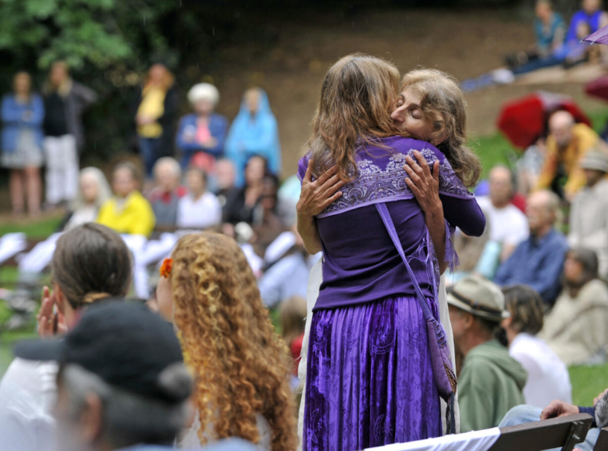 Asha Deliverance, the mother of Taliesin Myrddin Namkai-Meche, accepts a hug during a celebration of her son’s life in Lithia Park in Ashland, Ore., on June 7, 2017.