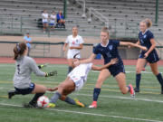 Union's MaKayla Woods, center, attempts to shoot past Gig Harbor goalkeeper Auna Havens on Thursday at McKenzie Stadium. Maddie Goss would score a few seconds later in Union's 4-1 win.