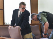 A Clark County corrections deputy removes shackles from Zachary Akers’ ankles before closing arguments in his child sexual exploitation trial April 27 at the Clark County Courthouse. Akers was convicted of multiple counts in that trial and later pleaded guilty in four other similar cases. He was sentenced Friday to 10 years in prison.