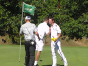 Union’s Dylan Henry, center, is congratulated by teammate Keith Lobis, right, after Henry won a playoff with Lobis and Prairie’s Dante Heitschmidt, left, to win the Jeff Hudson Invitational golf tournament at Tri-Mountain (Tim Martinez/The Columbian)