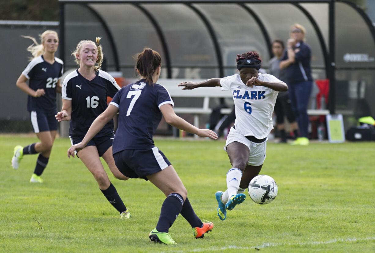 Clark's Facienne Graham (6) moves the ball past Clackamas' Zara Lindquist (7) during Saturday's afternoon soccer game at Clark College on Sept. 16, 2017. The Penguins won 5-0.