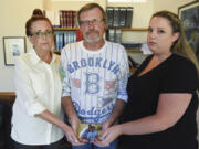 Mycheal Lynch’s stepmother Lila Fields, father Kim Lynch and sister Kelly Foster hold a photo of Mycheal with his niece. Mycheal Lynch was 32 in March 2015 when he died after a struggle in the Clark County Jail. Since his death, Lynch’s family has been working with attorneys Jack Green and Greg Ferguson to find answers and seek justice for their loved one.