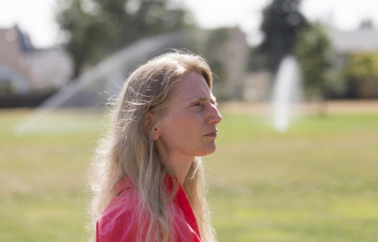 Parkside Neighborhood Association President Cheryl Aichele walks through Diamond Park. Aichele, who recently adopted the park, walks the path every morning and evening.