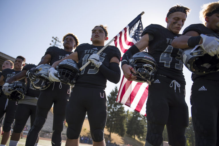 The Union Titans line up for the National Anthem before Friday night's game against Hermiston at McKenzie Stadium on Sept. 1, 2017.