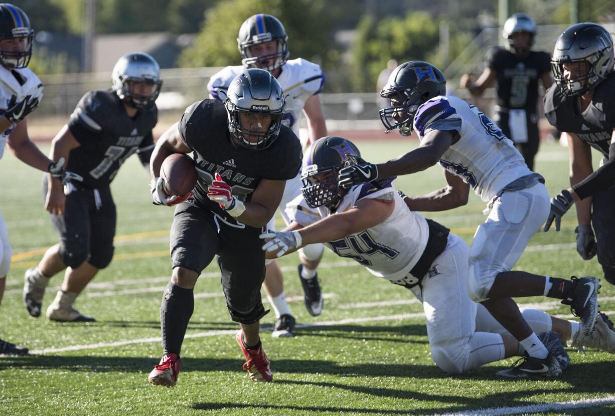 Union's Joseph Siofele (26) breaks through Hermiston defense scoring the team's second touchdown during Friday night's game against Hermiston at McKenzie Stadium on Sept. 1, 2017.