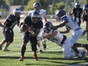 Union's Joseph Siofele (26) breaks through Hermiston defense scoring the team's second touchdown during Friday night's game against Hermiston at McKenzie Stadium on Sept. 1, 2017.