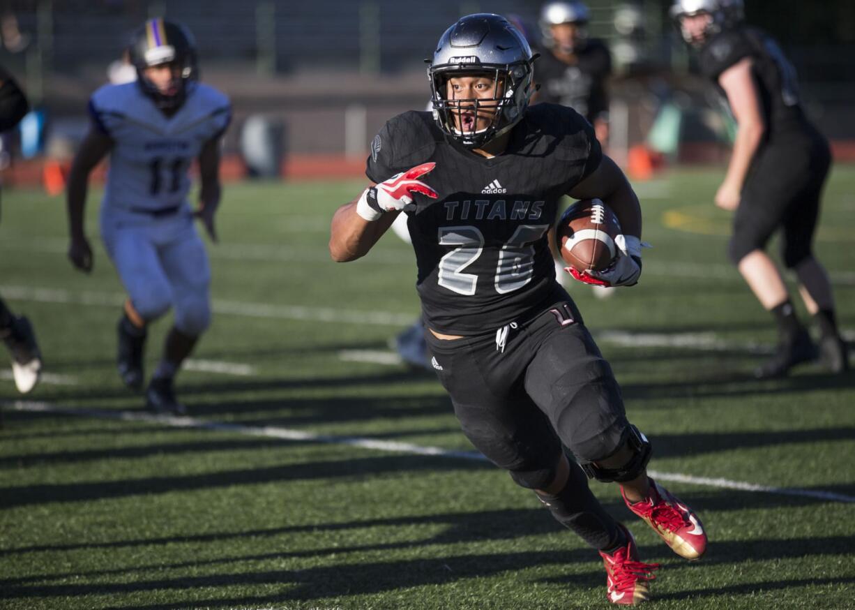 Titan Joseph Siofele (26) makes a second touchdown in the second half of their football game between Hermiston and Union High School at McKenzie Stadium in Vancouver on Friday, Sept. 1, 2017. The Titans beat the Bulldogs 35 to 21.