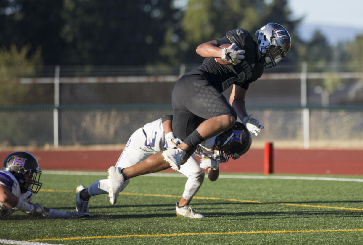 Titan Alishawuan Taylor (2) avoids Hermiston’s Jordan Ramirez (33) on his way to scoring a touchdown.